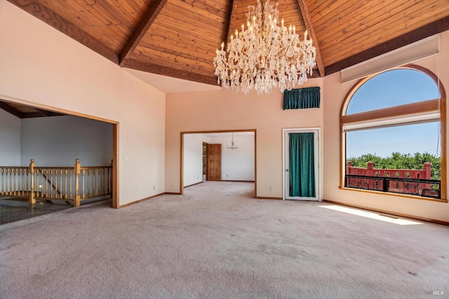 carpeted empty room with an inviting chandelier, wooden ceiling, baseboards, and high vaulted ceiling