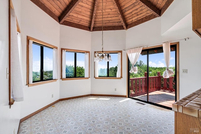 spare room featuring wooden ceiling, baseboards, beamed ceiling, and a notable chandelier