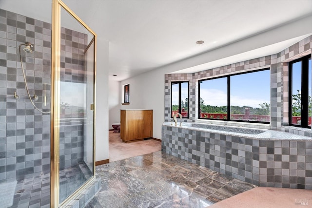 bathroom with a stall shower, baseboards, a garden tub, and recessed lighting