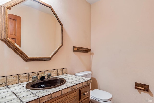 half bathroom with toilet and vanity