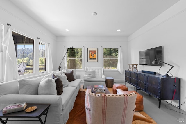 living area with recessed lighting and finished concrete floors