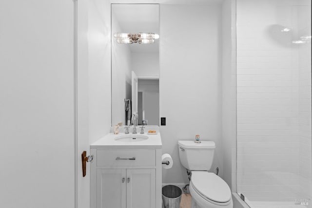 bathroom featuring vanity, toilet, and a shower stall