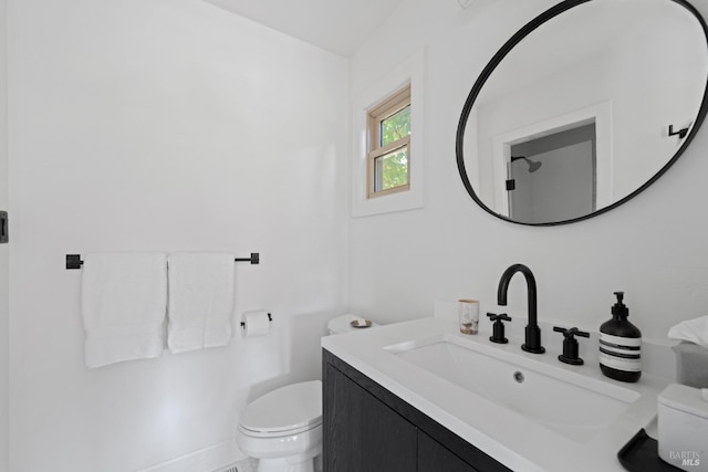 bathroom with toilet and vanity