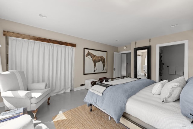 bedroom featuring baseboards and finished concrete floors