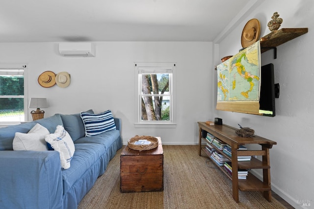 living room with plenty of natural light, baseboards, and a wall unit AC