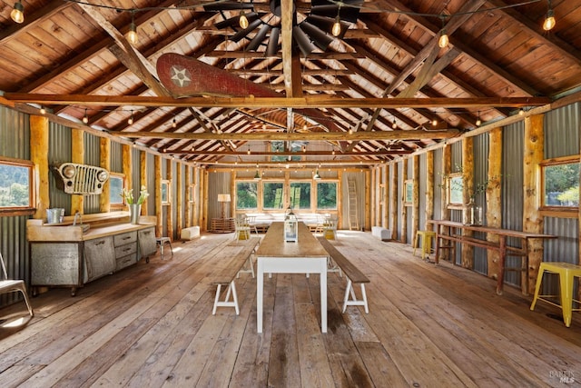 miscellaneous room with a healthy amount of sunlight, vaulted ceiling with beams, and hardwood / wood-style floors