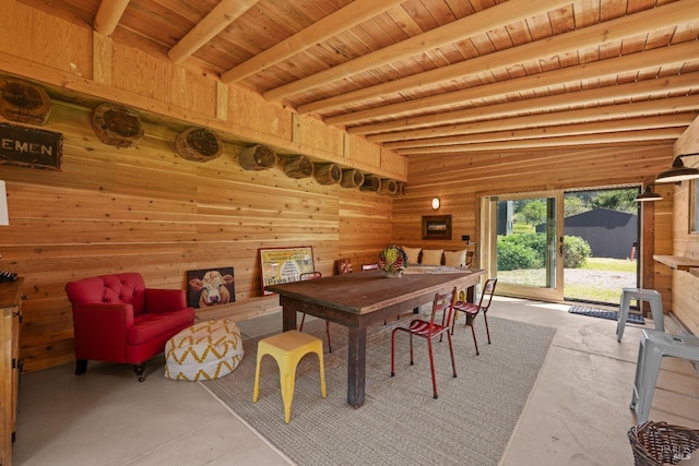 dining space featuring wood walls, concrete floors, beam ceiling, and wood ceiling