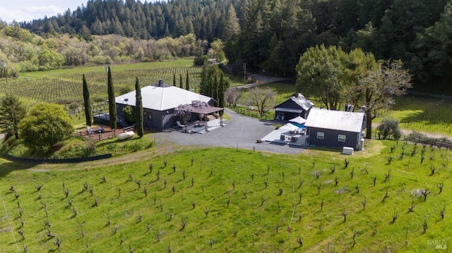 birds eye view of property with a view of trees and a rural view