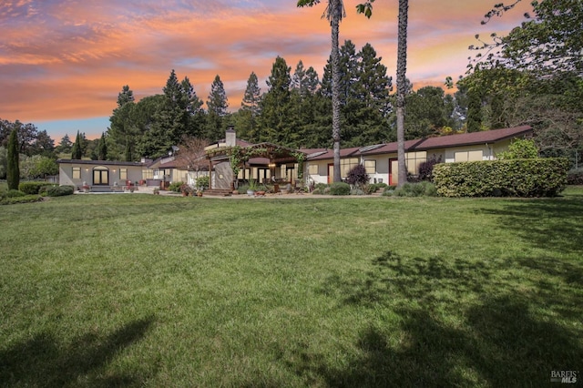 exterior space with a yard and a chimney