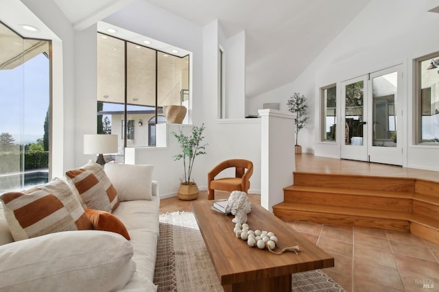 living room with high vaulted ceiling, tile patterned floors, baseboards, and recessed lighting