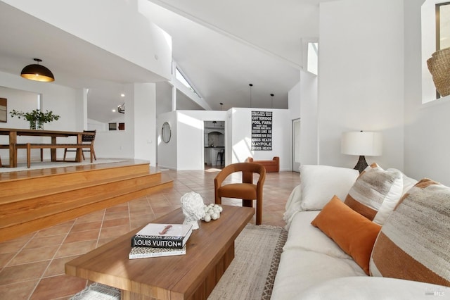 living room with tile patterned flooring and high vaulted ceiling