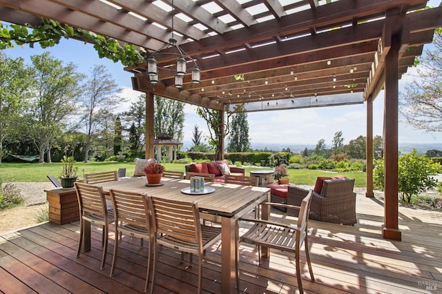 wooden terrace with a gazebo, an outdoor hangout area, a yard, a pergola, and outdoor dining space
