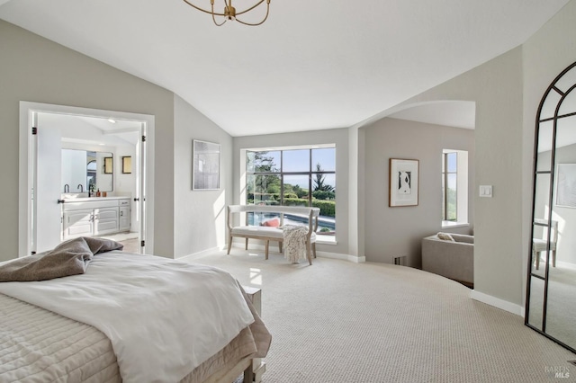 bedroom with carpet flooring, ensuite bath, a chandelier, baseboards, and lofted ceiling
