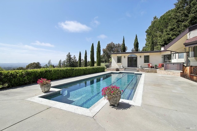 view of pool with a fenced in pool, a patio area, and french doors