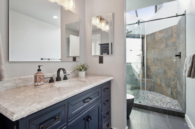 bathroom featuring vanity, tile patterned floors, a stall shower, and toilet