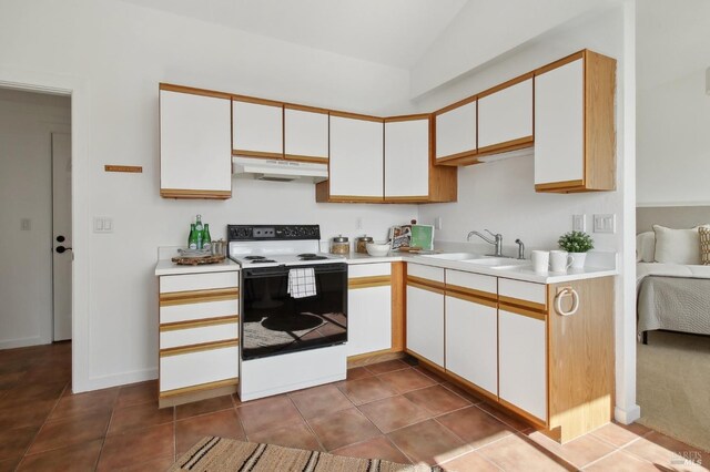 kitchen with electric range oven, light countertops, a sink, under cabinet range hood, and white cabinetry