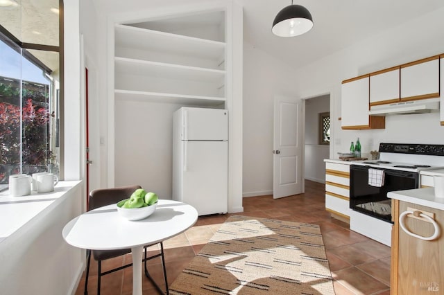 kitchen with range with electric cooktop, light countertops, white cabinets, freestanding refrigerator, and under cabinet range hood
