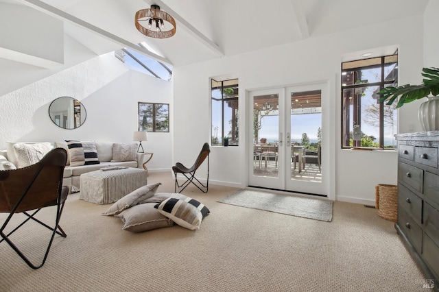 interior space with carpet floors, plenty of natural light, baseboards, and lofted ceiling with skylight