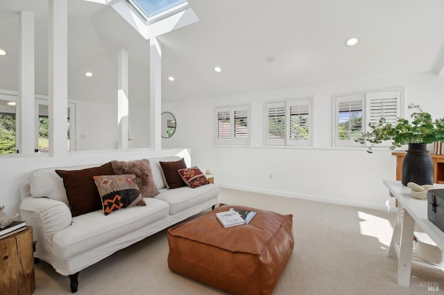 living area with carpet floors, recessed lighting, and vaulted ceiling with skylight