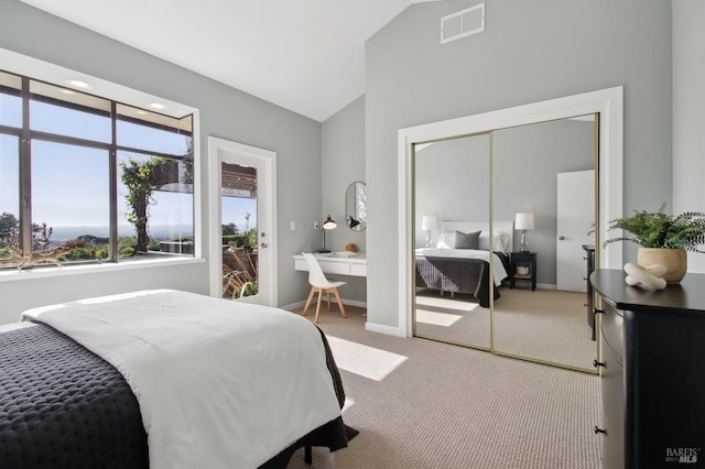 bedroom with visible vents, a closet, baseboards, carpet flooring, and vaulted ceiling