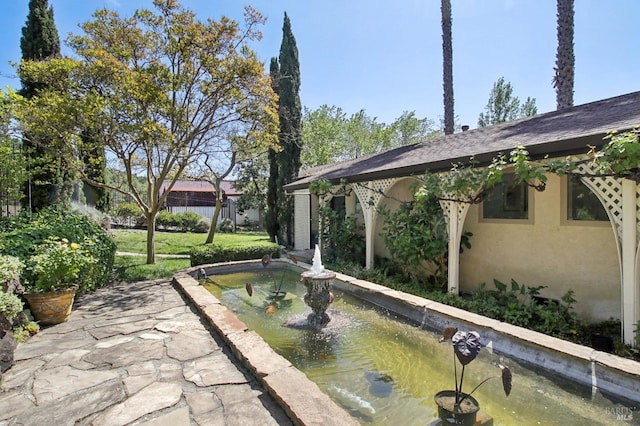 view of pool with a small pond