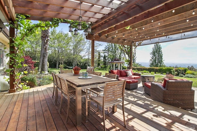 wooden terrace featuring a pergola, an outdoor living space, and outdoor dining area