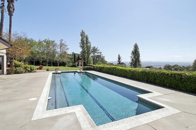 outdoor pool with a patio area