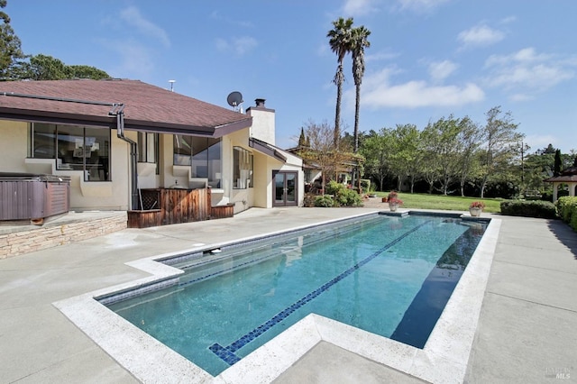 outdoor pool featuring a patio area and french doors