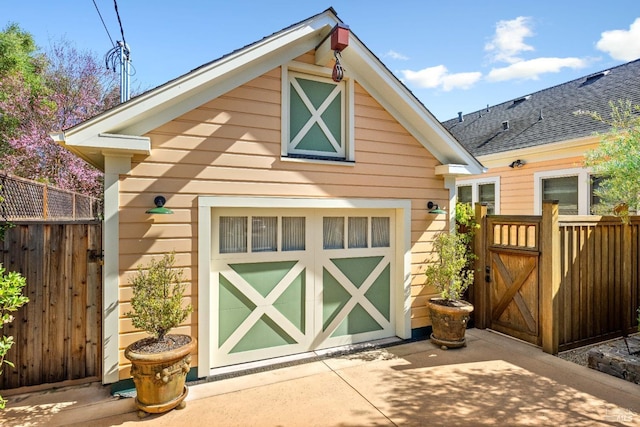 view of outbuilding featuring fence and an outdoor structure