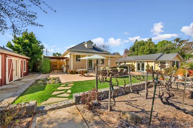back of property featuring fence and a patio area