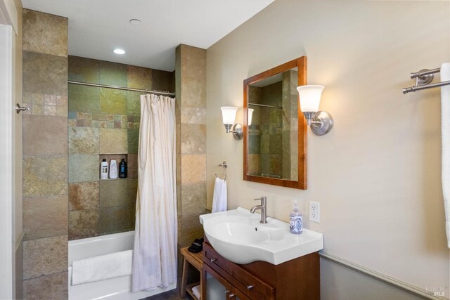 full bathroom featuring vanity and shower / bath combo with shower curtain