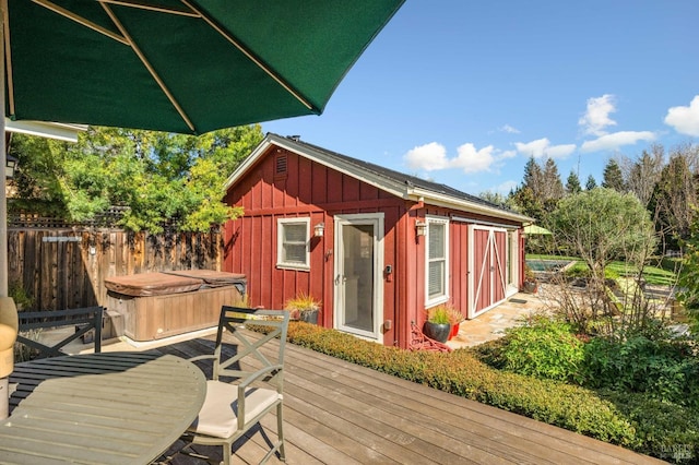 wooden terrace with fence and a hot tub