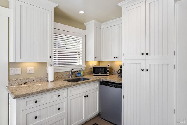 kitchen featuring a sink, white cabinetry, stainless steel microwave, and dishwasher