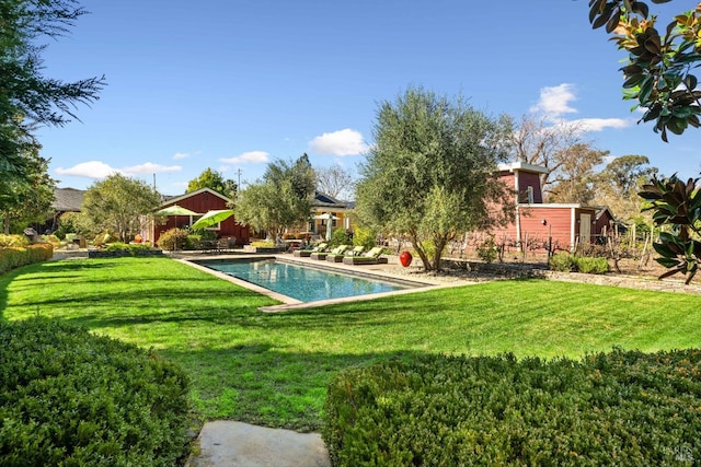 outdoor pool featuring a lawn and a patio area