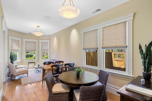 dining room with light wood-style floors and visible vents