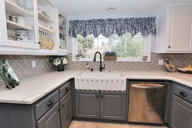 kitchen with a sink, dishwasher, gray cabinets, white cabinetry, and glass insert cabinets