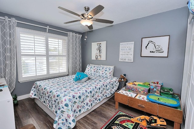 bedroom with baseboards, ceiling fan, and wood finished floors
