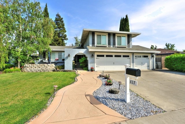 view of front of house featuring roof with shingles, a front lawn, concrete driveway, an attached garage, and stucco siding