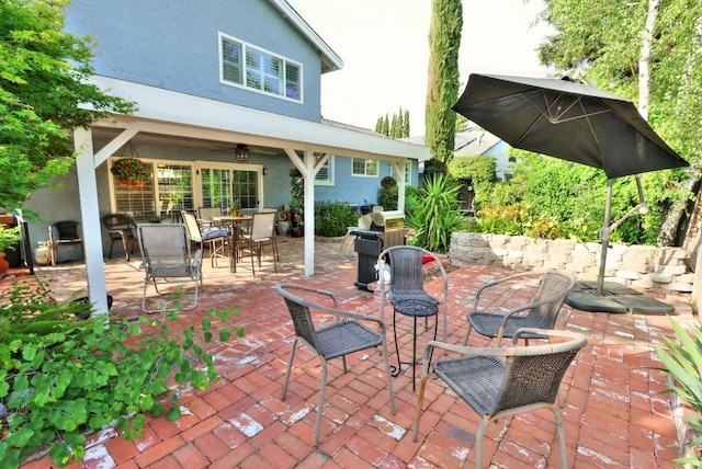 view of patio with grilling area, ceiling fan, and outdoor dining area