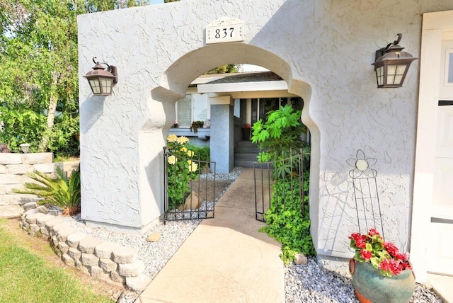 doorway to property featuring stucco siding