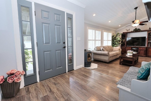 entrance foyer featuring baseboards, ornamental molding, a ceiling fan, and wood finished floors
