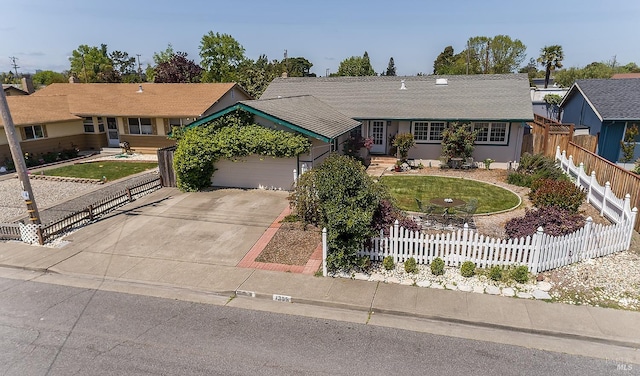 single story home featuring fence private yard, an attached garage, driveway, and a front lawn