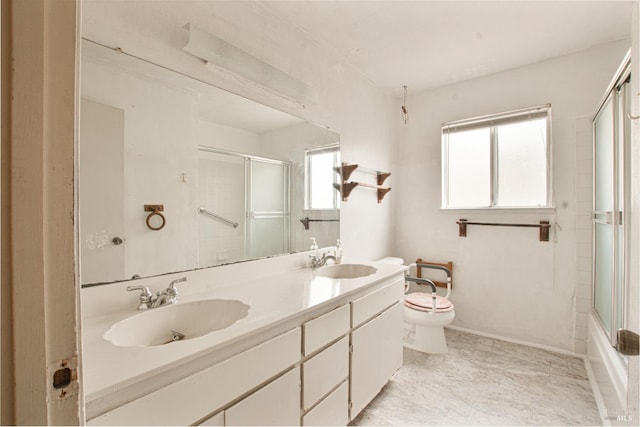 full bathroom with toilet, double vanity, and baseboards