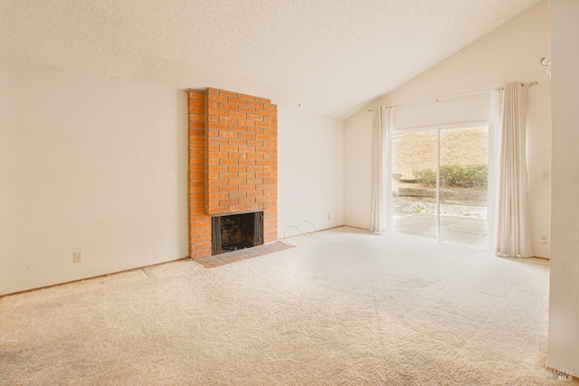 unfurnished living room featuring a brick fireplace, vaulted ceiling, carpet flooring, and a textured ceiling