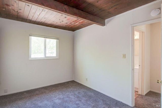 spare room with wood ceiling, beamed ceiling, and carpet flooring