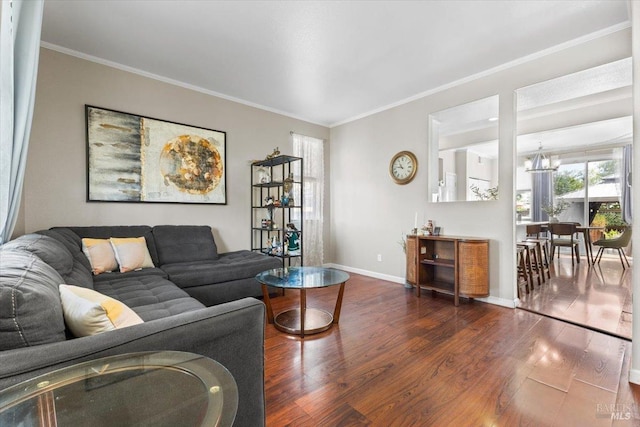 living area with crown molding, baseboards, and wood finished floors