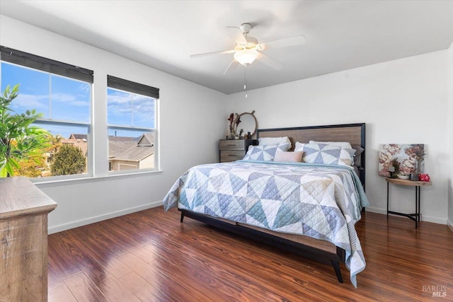 bedroom featuring baseboards, ceiling fan, and wood finished floors
