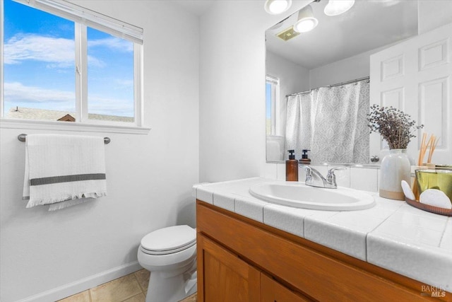 bathroom with tile patterned flooring, vanity, toilet, baseboards, and visible vents