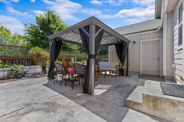 view of patio / terrace featuring a fenced backyard, outdoor dining space, a gazebo, and outdoor lounge area