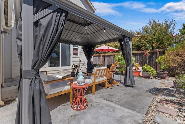 view of patio / terrace featuring fence and a gazebo